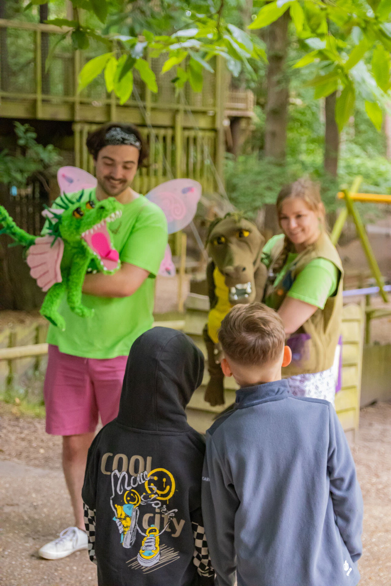 Two children meeting Minty and Mildred puppets at BeWILDerwood