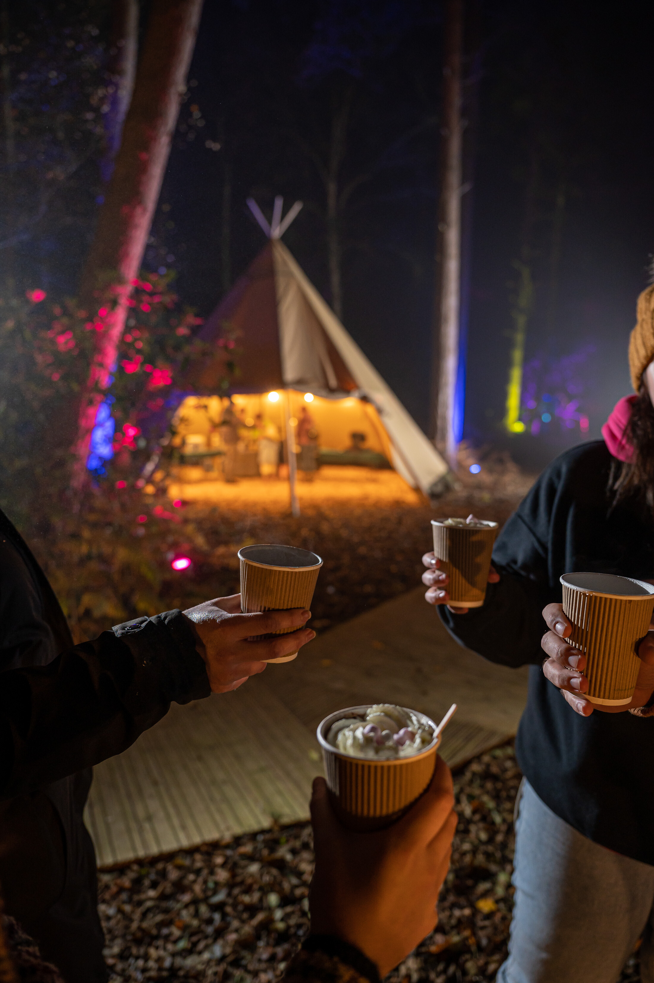 Four people holding hot chocolates at BeWILDerwood