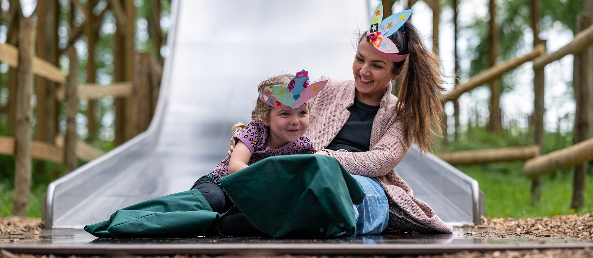 Family on a slide wearing crafted crowns