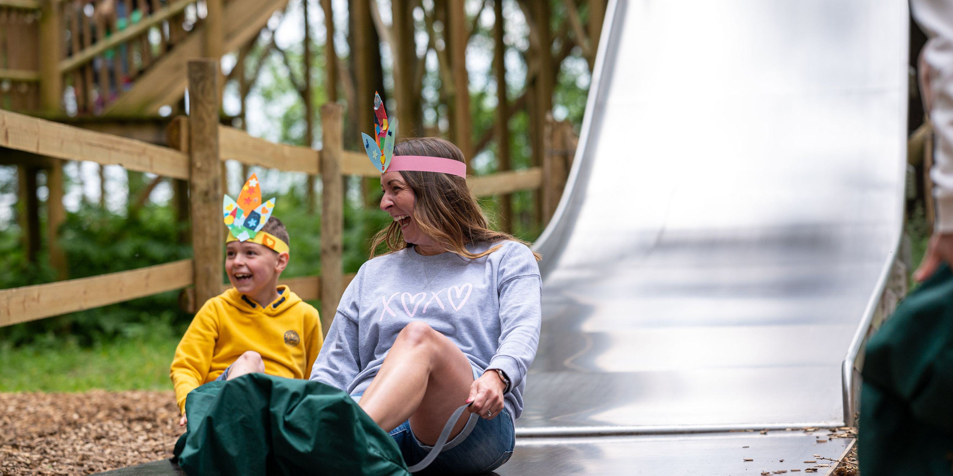 Mum and son going down a slide