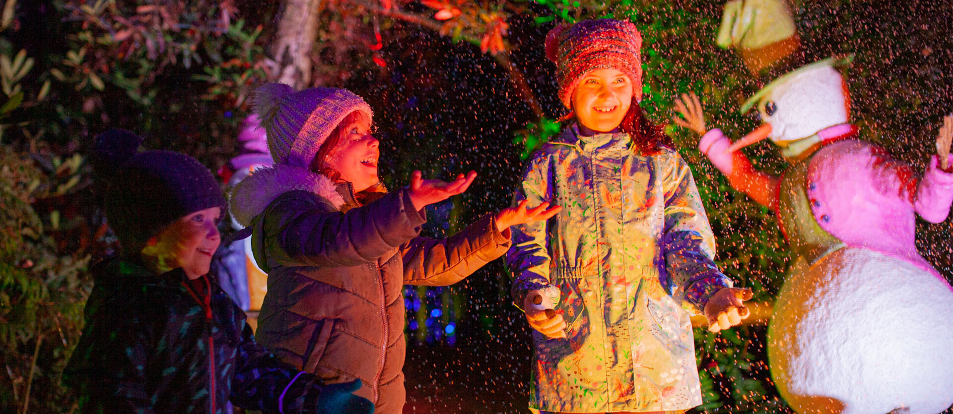 Children play in the snow during BeWILDerwood Presents Christmas