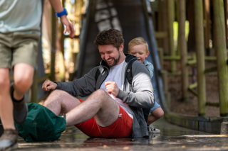 A family having fun on a big slide.