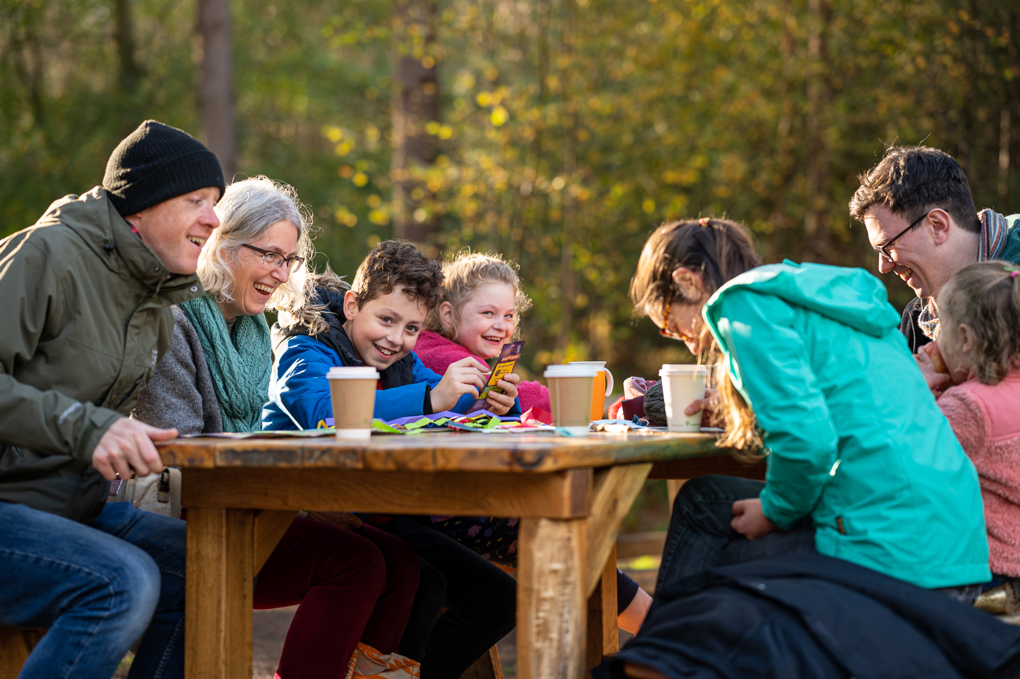 People eating at a picnic table at bewilderwood