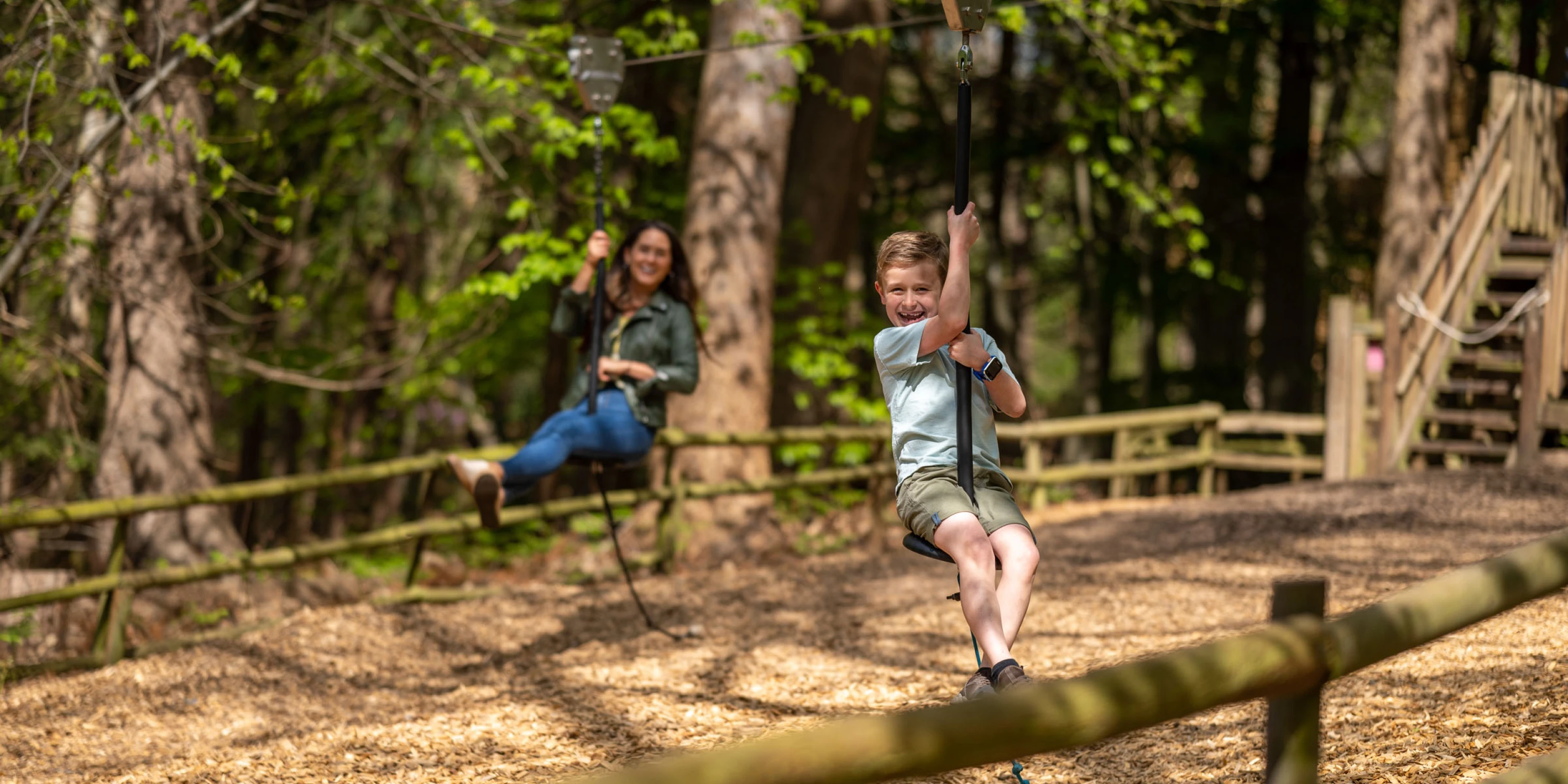 Mum and son on zip wires at Bewilderwood