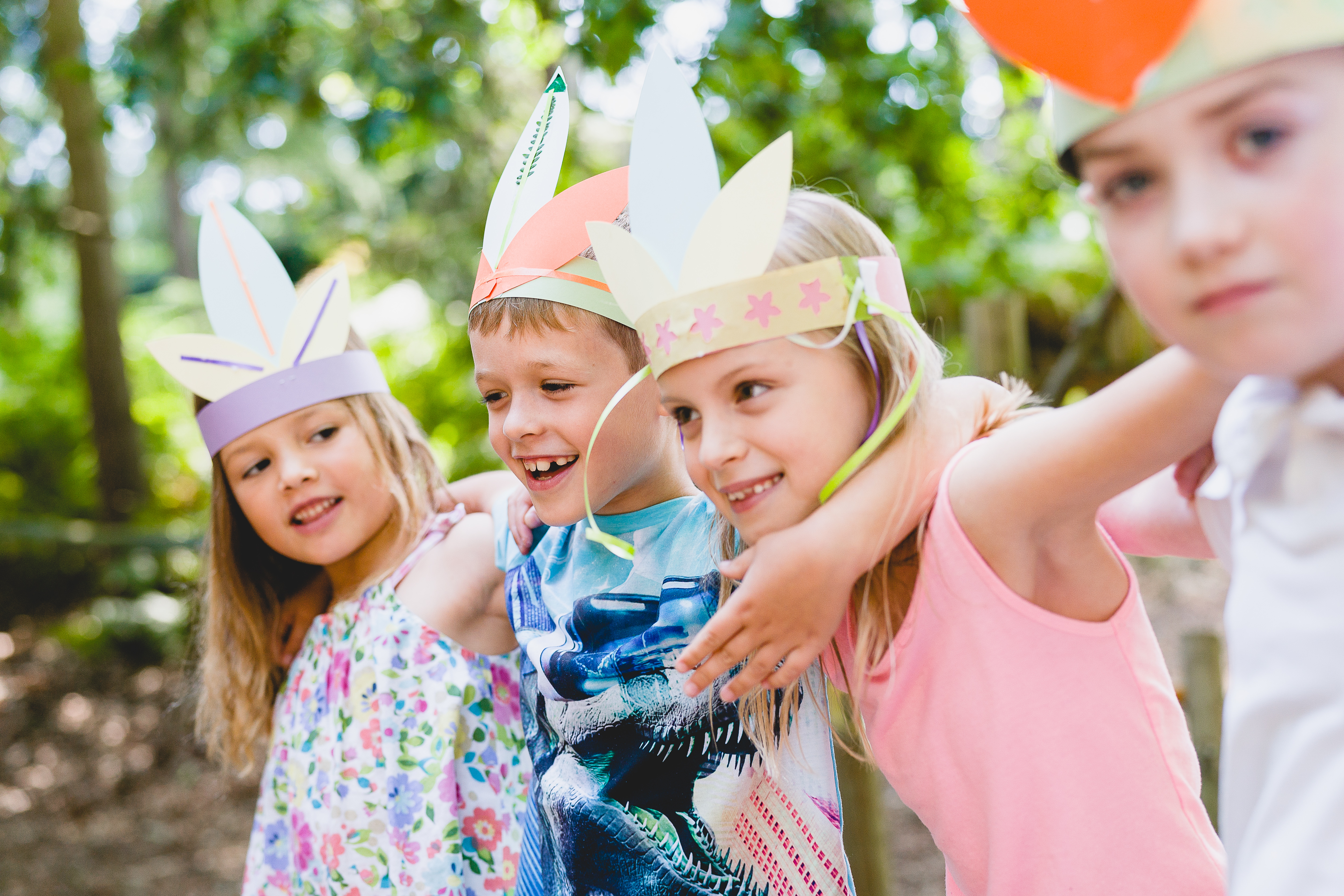 Children wearing crafted crowns at bewilderwood