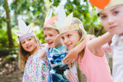 Children wearing crafted crowns at bewilderwood