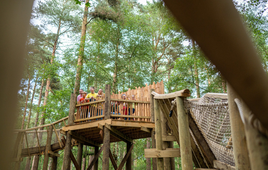 Family stood on wooden structure at Bewilderwood
