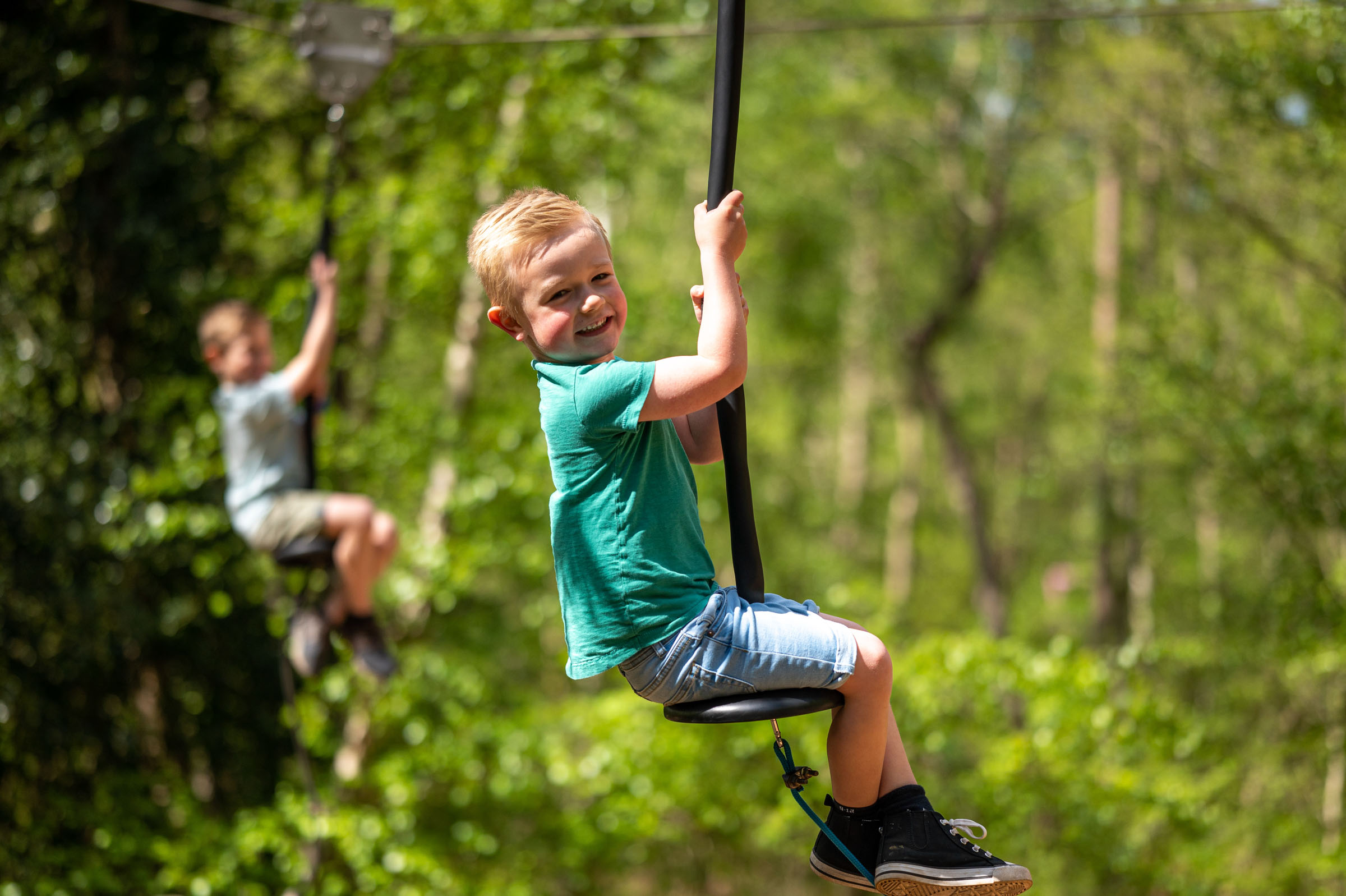 Boy playing on zip wire at bewilderwood