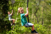 Boy playing on zip wire at bewilderwood