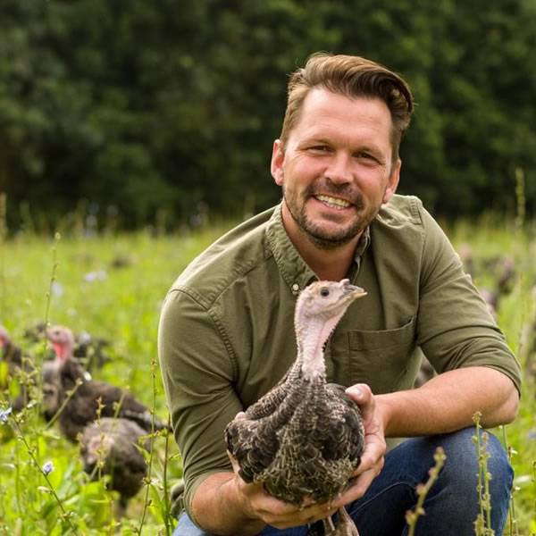 Jimmy from Jimmy's Farm holding a baby turkey