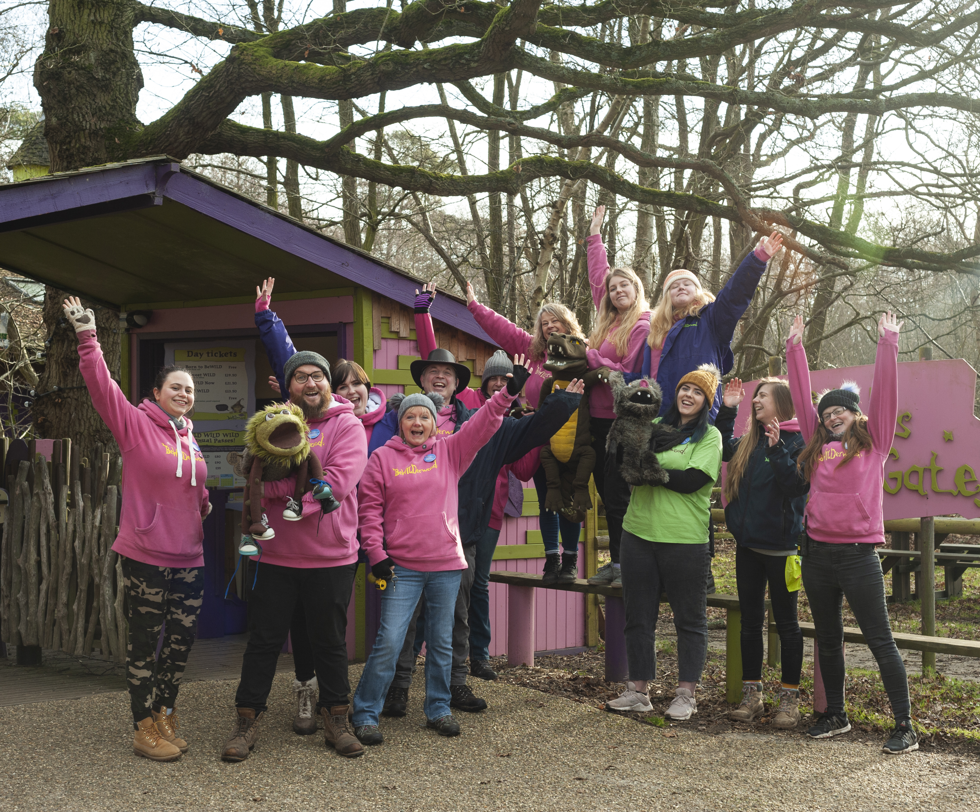 A group of staff posing outside a colourful building
