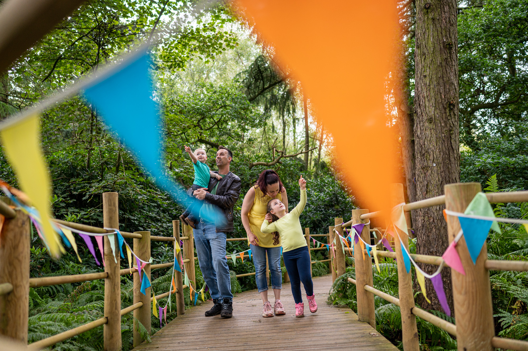 Family walking down wooden trail at bewildewood