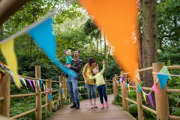 Family walking down wooden trail at bewildewood