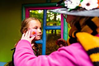 Girl getting face stencils