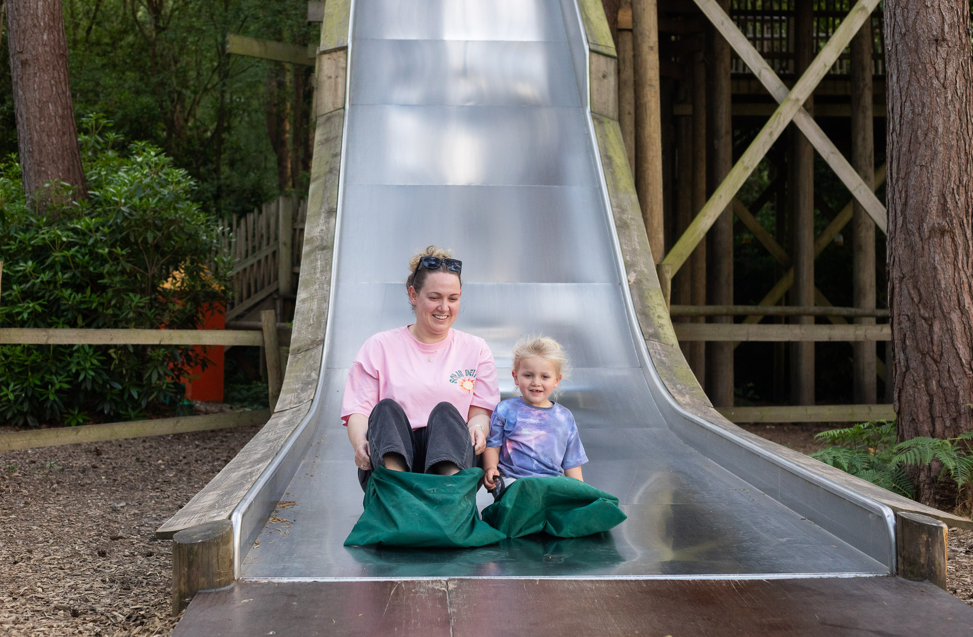 Mum and daughter on a slide at bewilderwood