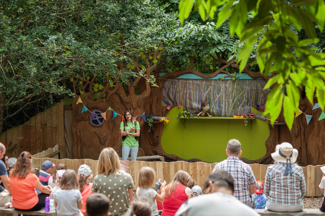 Crowd watching a show at a stage at bewilderwood