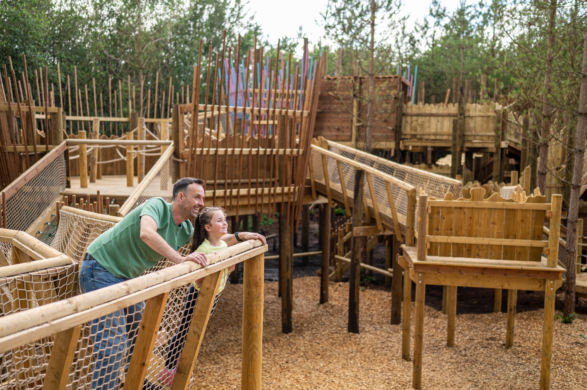Dad and daughter on wooden structure at bewilderwood